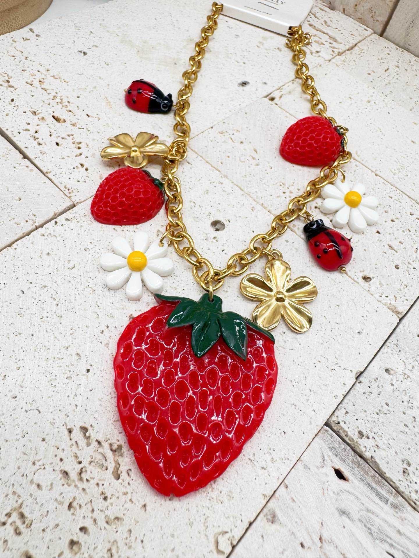 Collana donna in acciaio dorato collezzione frutta fragola margherita coccinella pop
