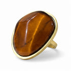 Anello donna Shelly in acciaio dorato con pietra ovale occhio di tigre e misura regolabile.