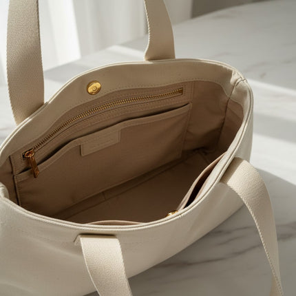 Tempo A Tempo beige faux leather tote bag interior view with zip pocket and magnetic closure on a marble surface