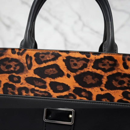 Tempo A Tempo set of 3 black leather handbags with leopard print detail and adjustable shoulder strap.