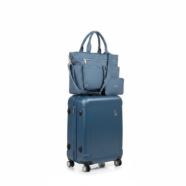 Tempo A Tempo blue nylon tote bag with multiple pockets and matching wallet, stacked on a blue suitcase.