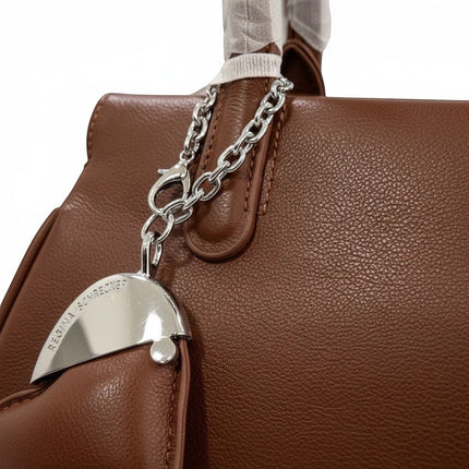 Tempo A Tempo brown ecopelle mini bag with silver heart charm and chain detail. Structured doctor bag style with top handles and detachable shoulder strap.