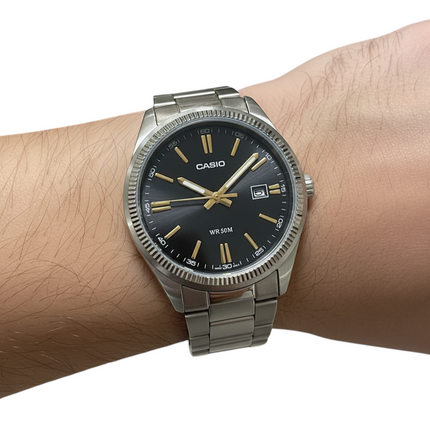 Tempo A Tempo men's analog watch with black dial, gold indices, stainless steel bracelet, and date window. Water resistant 50m.