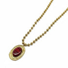 Collana da donna Tempo A Tempo in acciaio dorato con catena a sfere e ciondolo ovale con resina rossa martellata.