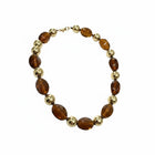 Tempo A Tempo Collana girocollo da donna con pietre ambra sfumate e sfere dorate lucide, montatura oro.