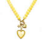 Collana Tempo A Tempo gialla con perline in resina, chiusura T-bar e ciondoli dorati a forma di cuore e stella