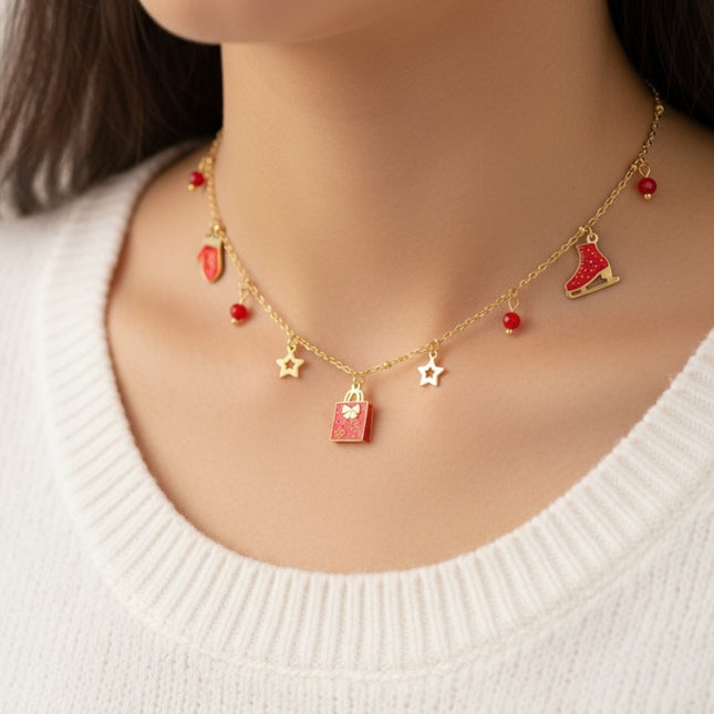 Collana Tempo A Tempo in acciaio oro con ciondoli natalizi rossi, pattino, pacchetto regalo e stelline
