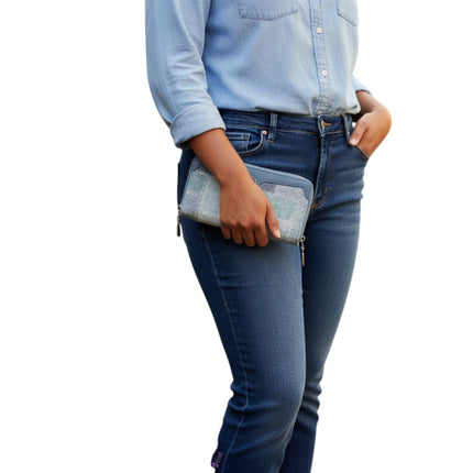 Tempo A Tempo Coveri denim patchwork wallet with double silver zip held by a woman in blue jeans