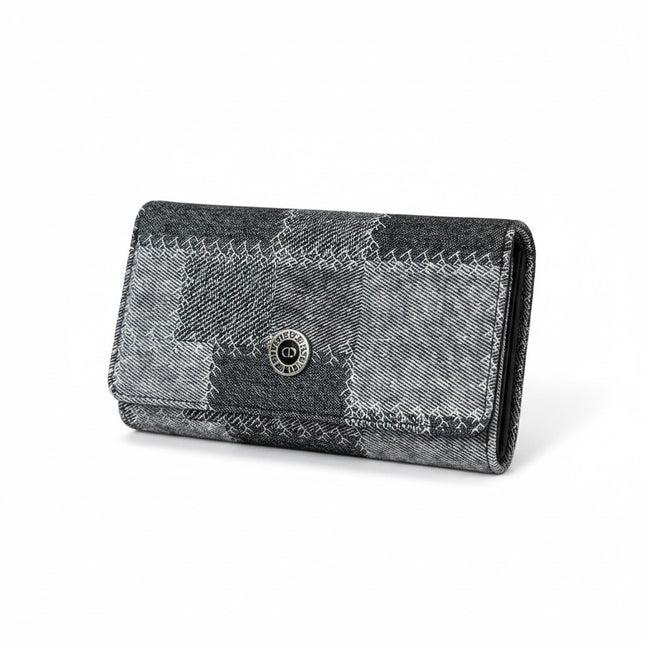 Tempo A Tempo Coveri continental wallet in grey and black denim patchwork fabric with a silver logo button closure.