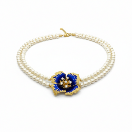 Tempo A Tempo double strand pearl necklace with a blue enamel gold flower pendant with crystals.