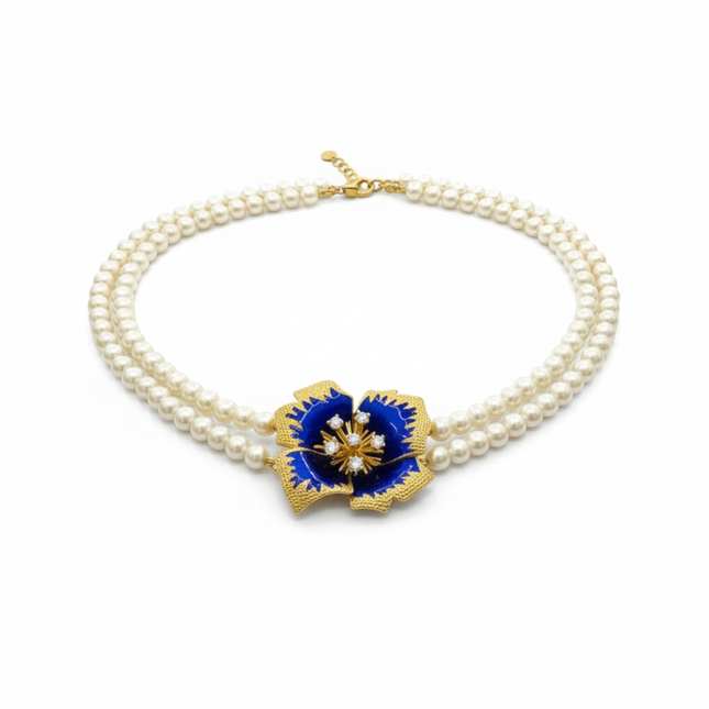 Tempo A Tempo double strand pearl necklace with a blue enamel gold flower pendant with crystals.
