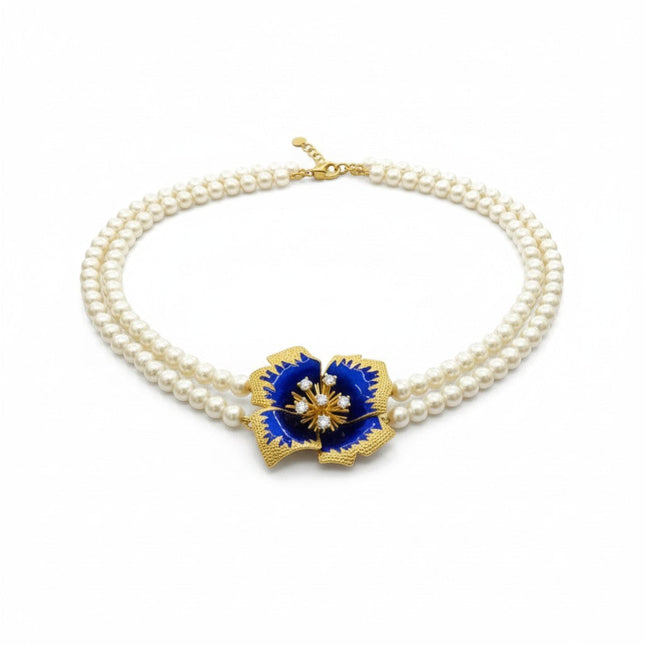 Tempo A Tempo Shelly double-strand pearl necklace with a blue enamel flower pendant and gold baroque accents.