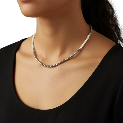 Tempo A Tempo Shelly necklace featuring white and grey glass pearls worn by a model in a black top