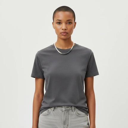 Tempo A Tempo Shelly glass pearl necklace with stainless steel clasp worn by a model in a dark grey t-shirt