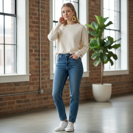 Tempo A Tempo gold hammered open teardrop earrings worn by a woman in a casual cream sweater and blue jeans