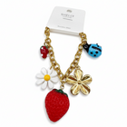 Tempo A Tempo gold-tone stainless steel bracelet with strawberry, ladybug, daisy, and flower charms. Adjustable.