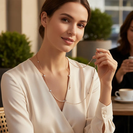 Tempo A Tempo Guess gold-tone steel necklace with crystal accents worn by a woman in a white blouse