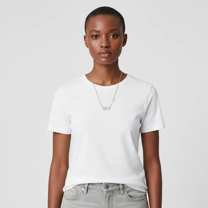 Tempo A Tempo GUESS rose gold infinity necklace worn by a model in a white t-shirt