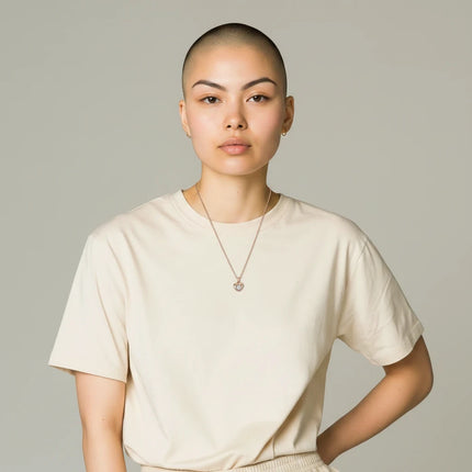 Tempo A Tempo model wearing a Guess rose gold stainless steel necklace with a heart pendant and crystal detail