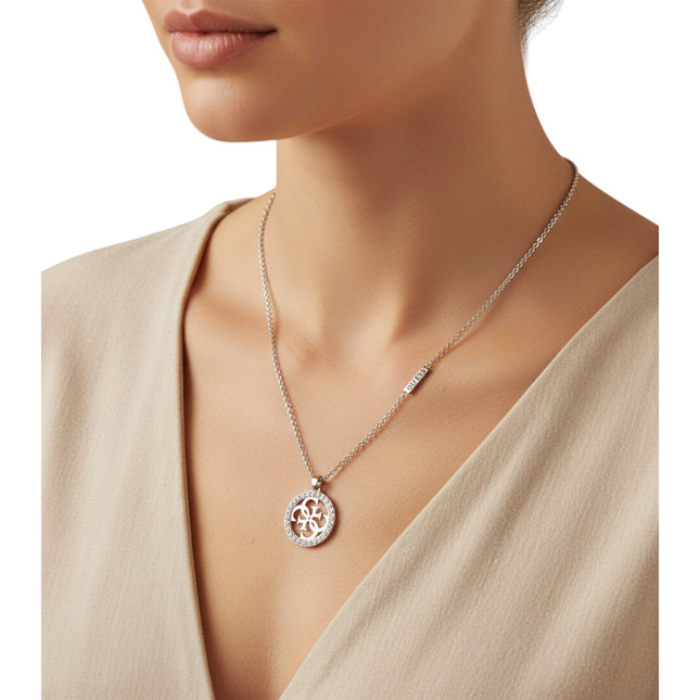 Tempo A Tempo Guess silver-tone stainless steel necklace with crystal-embellished logo pendant worn on a model