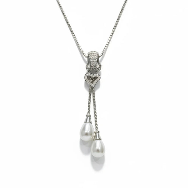 Tempo A Tempo long necklace in 316L stainless steel with a heart pendant, cubic zirconia, and two white pearls.