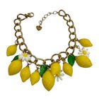 Tempo A Tempo gold-tone chain bracelet with yellow lemon and white daisy charms, green leaves, and adjustable clasp.
