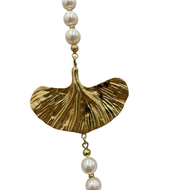 Tempo A Tempo long pearl necklace with gold ginkgo leaf charms. Elegant women's jewelry.