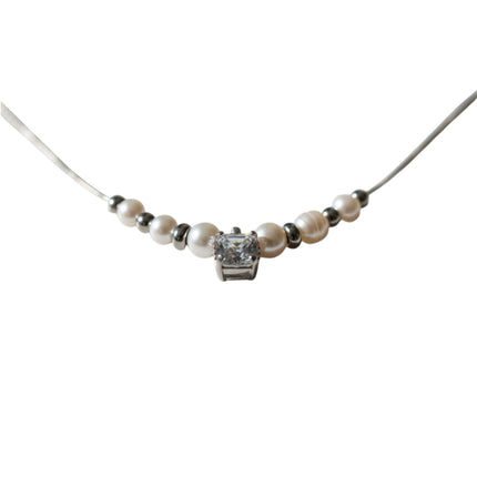 Tempo A Tempo necklace with white synthetic pearls, silver-tone beads, and a central faceted crystal on steel chain.