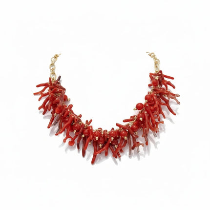 Tempo A Tempo ethnic style choker necklace featuring red synthetic coral branches and gold beads on a white background.