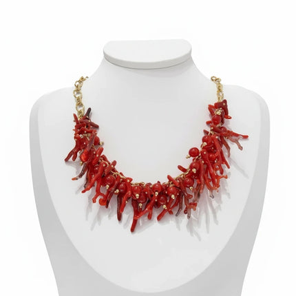 Tempo A Tempo ethnic style choker necklace with red synthetic coral branches and gold beads on a white mannequin