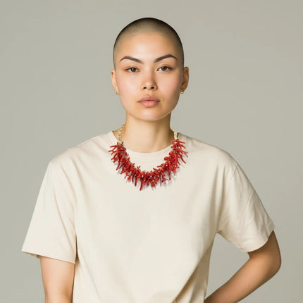 Tempo A Tempo ethnic style choker necklace with red synthetic coral branches and gold beads worn by a model