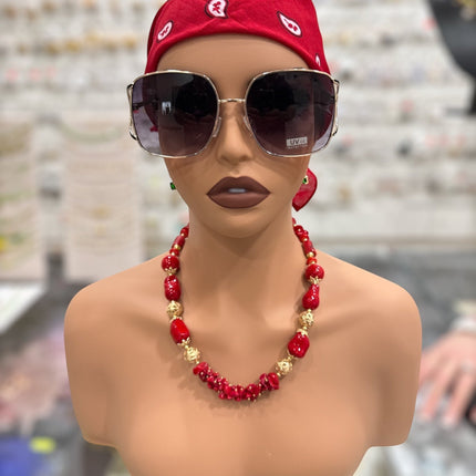 Tempo A Tempo statement necklace with red coral-effect resin beads and gold-tone metal spheres on a mannequin