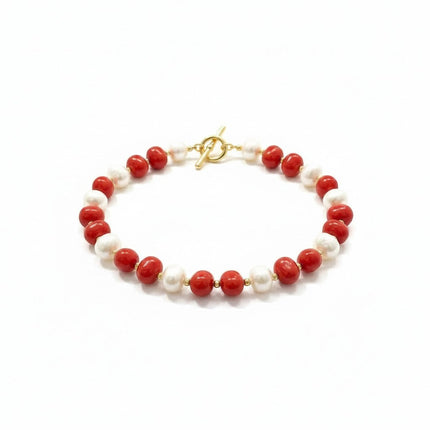 Tempo A Tempo necklace featuring alternating white and red shell powder pearls with gold-tone metal T-bar clasp.