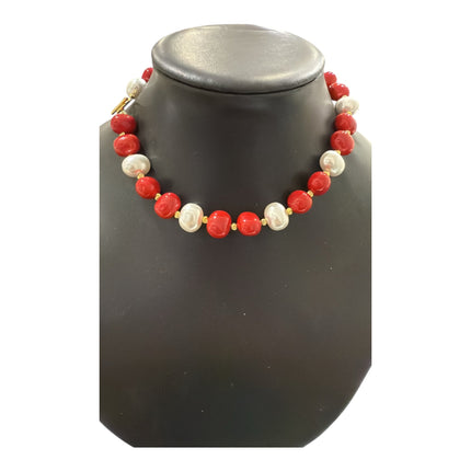 Tempo A Tempo necklace featuring alternating red and white shell powder pearls with gold-tone T-bar clasp on a display