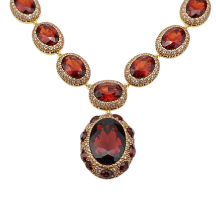 Tempo A Tempo 4-piece vintage ruby red crystal and gold-tone jewelry set with necklace, bracelet, earrings, and ring.