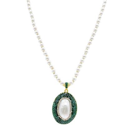Tempo A Tempo Shelly necklace with white pearls and an oval pendant featuring green crystals and gold accents