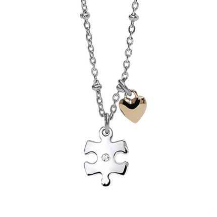 Tempo A Tempo silver and gold tone stainless steel puzzle piece necklace with a small heart charm and a crystal accent.