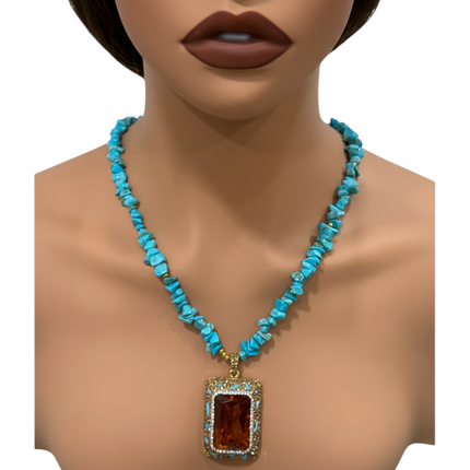 Tempo A Tempo artisanal necklace with turquoise chips and rectangular amber crystal pendant. Features unique stone variations.