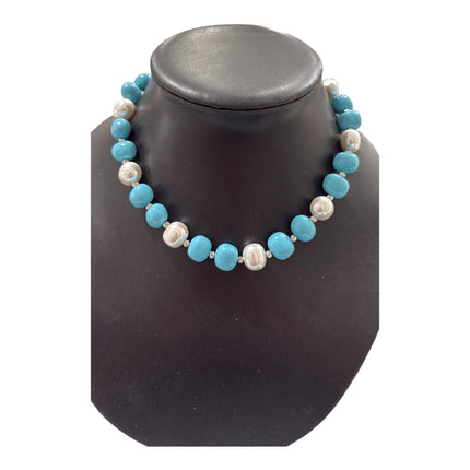Tempo A Tempo necklace with alternating white and turquoise shell powder beads and silver-tone accents on a display